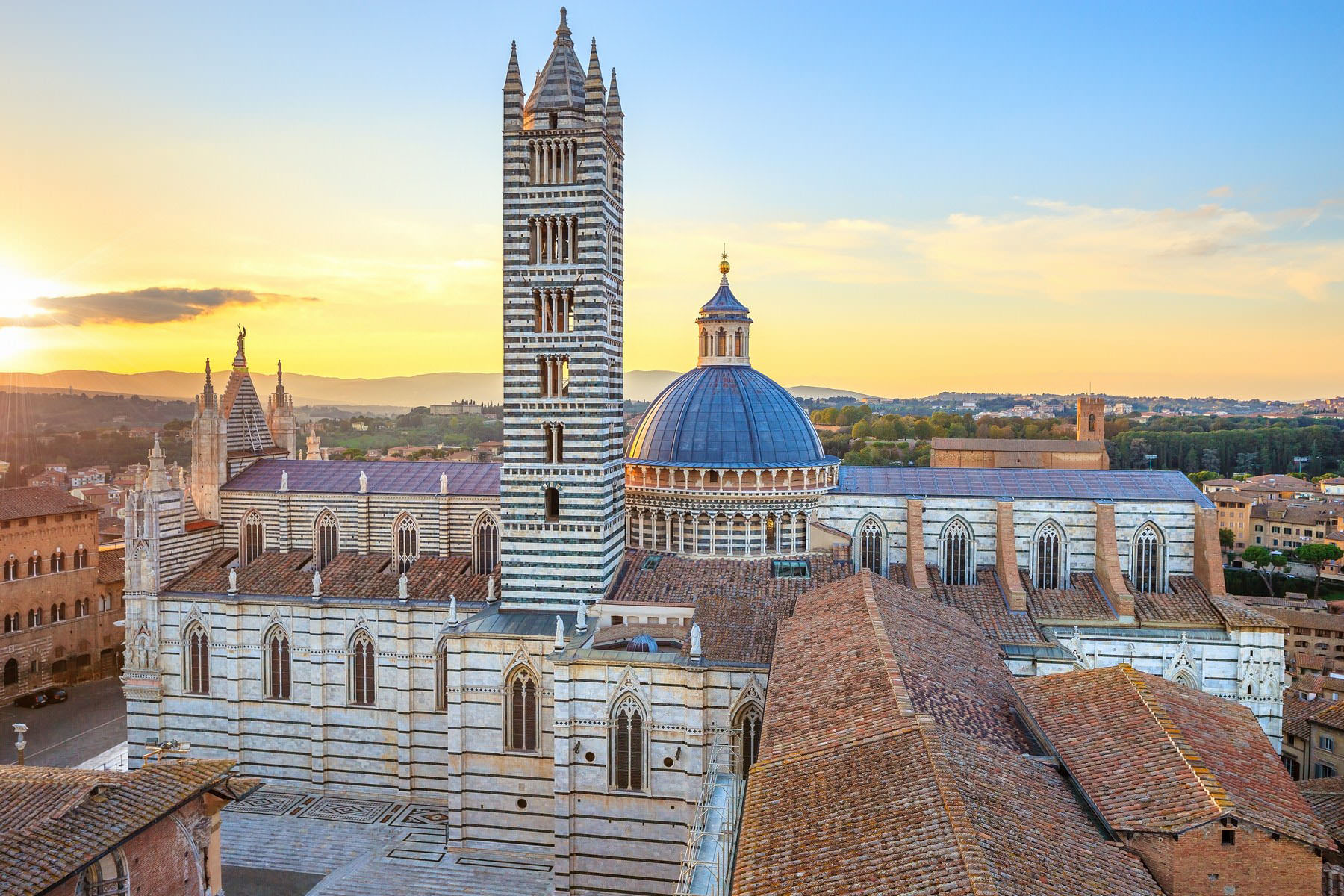 Siena aerial sunset panoramic view. Cathedral Duomo landmark. Tuscany, Italy.
